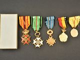 several medals and medals are arranged in a row on a black surface