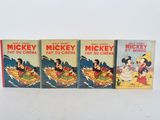 three vintage mickey and mickey mouse books are lined up on a white surface