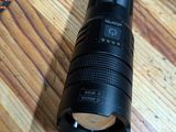 a flashlight that is sitting on a wooden table