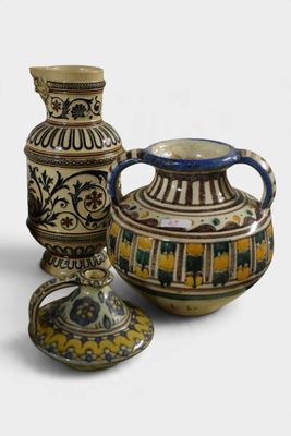 three different vases sitting next to each other on a table