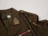 an image of a jacket with a ribbon and a badge on it