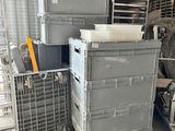 a pile of boxes and crates in a warehouse