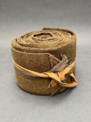 a roll of brown fabric with a brown ribbon tied to it