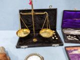 a gold scale sitting on top of a table next to other items