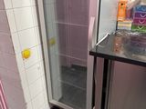 a small bathroom with a sink and a shower stall