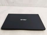 a laptop that is sitting on a bed with a white sheet