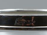 a close up of a silver ring with two skulls on it