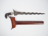 an old knife with a wooden handle sitting on top of a white surface