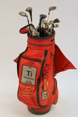 an image of a golf bag filled with golf clubs on a white surface
