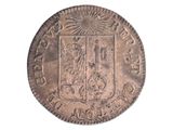 une vieille pièce d'argent sur laquelle figure un blason