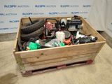 a wooden box filled with assorted items on the floor