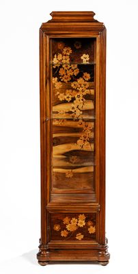 a tall wooden cabinet with a floral design on it