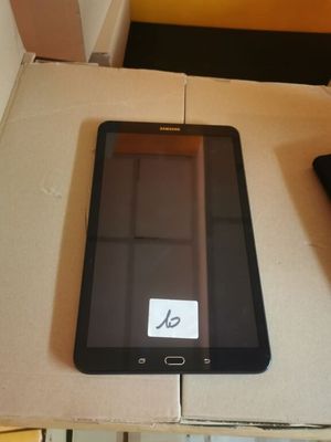 a tablet computer sitting on top of a box next to a remote