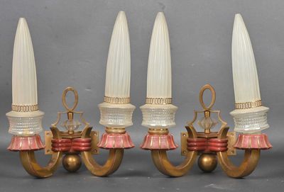 three antique brass and glass wall sconces with pink tassels