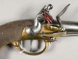 a silver and gold gun on a white surface