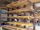 many wooden shelves in a warehouse with a metal roof