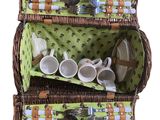 a wicker picnic basket with tea cups and utensils in it