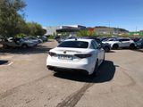a white car that is parked in a parking lot
