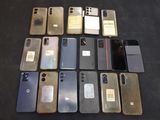 a lot of cell phones that are sitting on a table