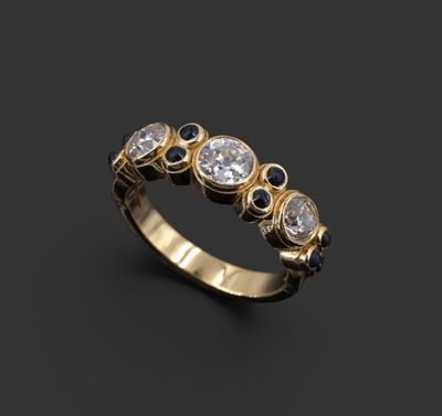 Bague jarretière en or jaune 18K sertie-clos de trois diaman…