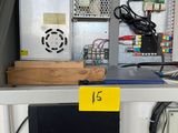 a computer on a desk with a lot of wires on it