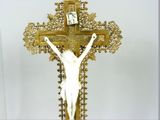a statue of jesus on a cross with a clock on it