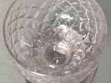 a glass with ice in it sitting on a table