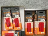 three boxes of wokin batteries in a cardboard box on a carpet