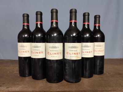 six bottles of wine are lined up on a wooden table