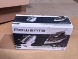 packaging of a black and white steam iron sitting on the floor