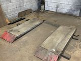 two pieces of metal sitting on the floor in a room