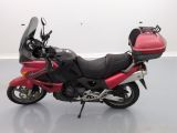 a picture of a red and black motorcycle parked in a room
