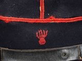 a close up of a hat with a red trim