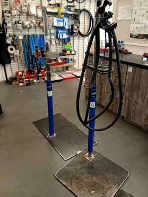 a picture of a bike repair shop with tools on the floor