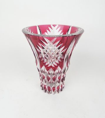 a glass vase that is sitting on a white surface