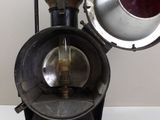 an old fashioned lamp that is on a white table