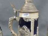 three beer mugs with a picture of a castle and a castle on them
