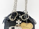 a black purse with a gold heart charm on it