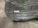 a roll of wire wrapped in plastic on the ground