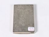 an old silver cigarette case with a sticker on it