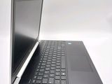 a laptop that is open on a white surface