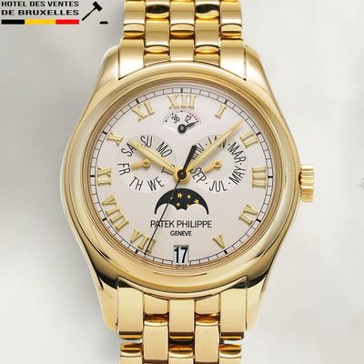 a gold wrist watch with a white dial on a gold bracelet