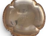 an antique silver plate on a white background with a gold border