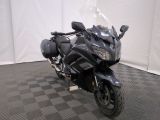 a motorcycle that is parked on a checkered floor