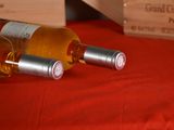 two bottles of wine sitting on a red table