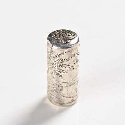a close up of a silver object on a white surface