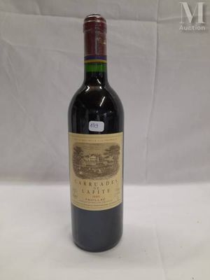 the bottle of red wine is sitting on the table