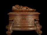a wooden box with a statue on top of it