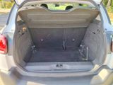 the back of a car with its trunk open and the back door open