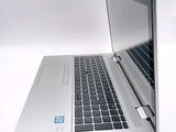 a silver laptop with a blue sticker on the screen